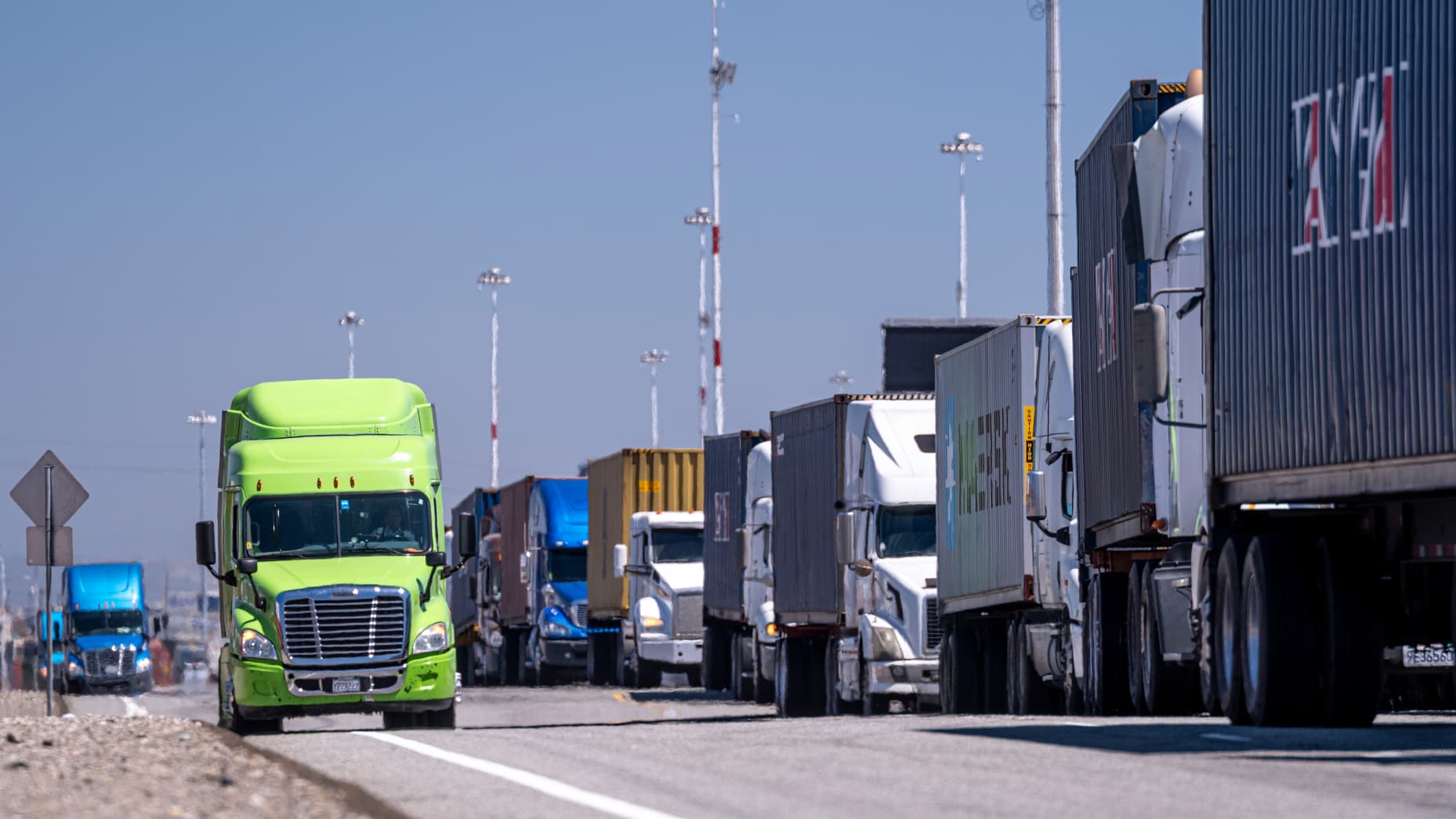 Freight trucks in a queue at a US border crossing.