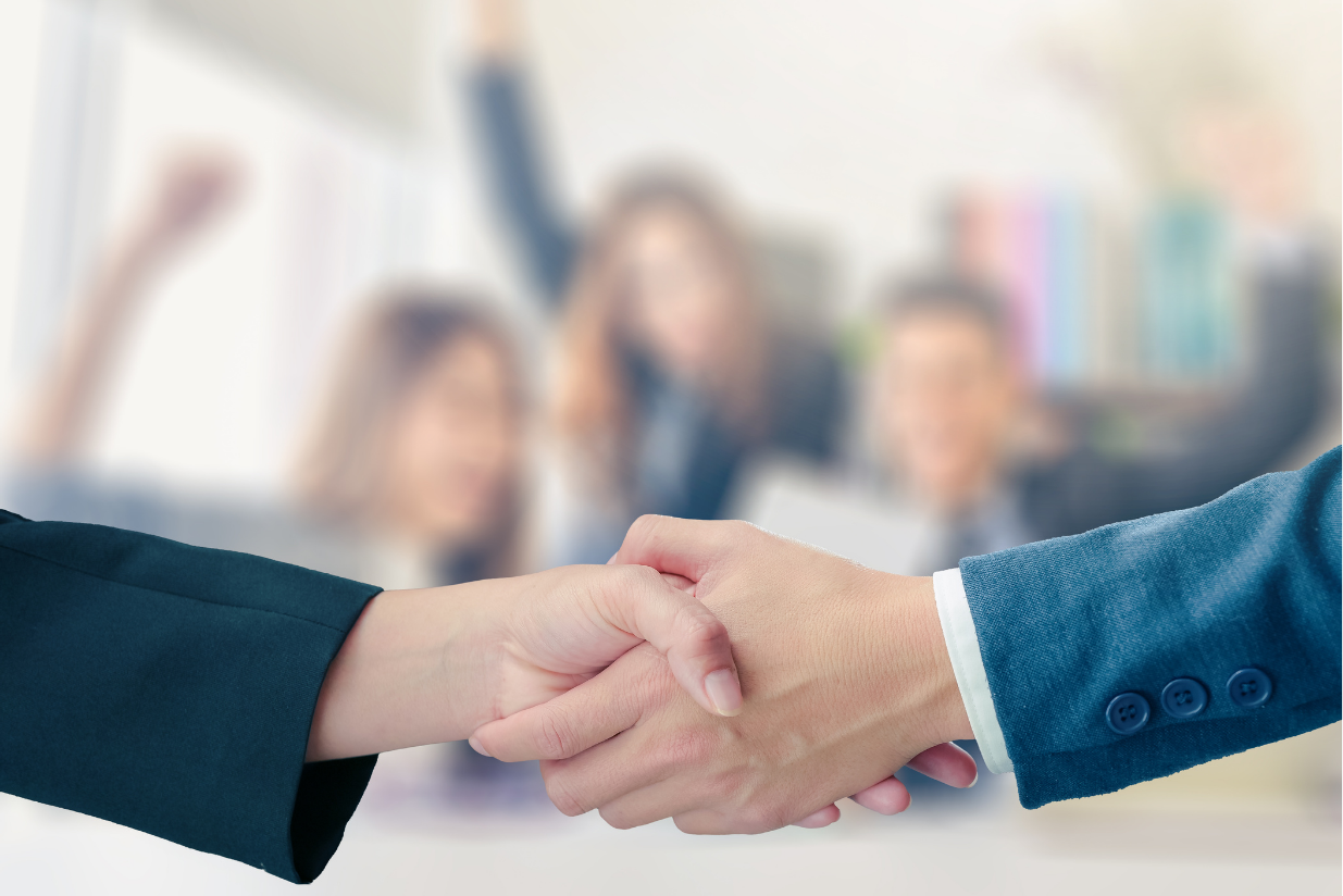 Two businesspeople shaking hands, symbolizing partnership and collaboration