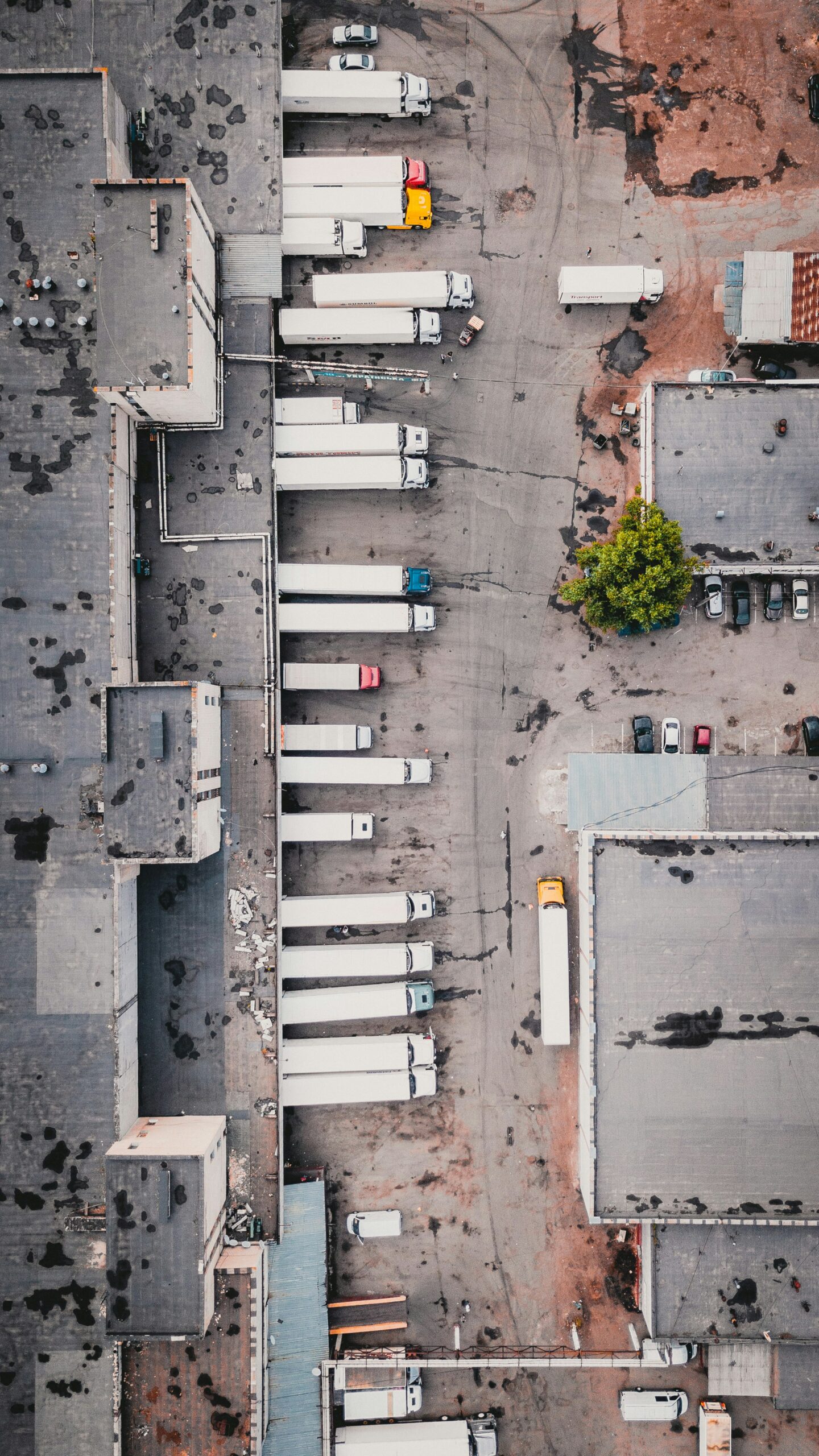 Aerial view of a busy logistics hub with trucks and warehouses