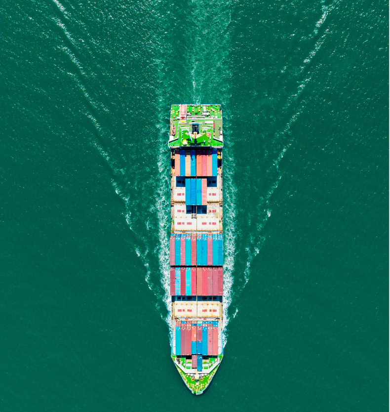 Top-down view of a massive container ship loaded with colorful shipping containers, cutting through the blue ocean waters