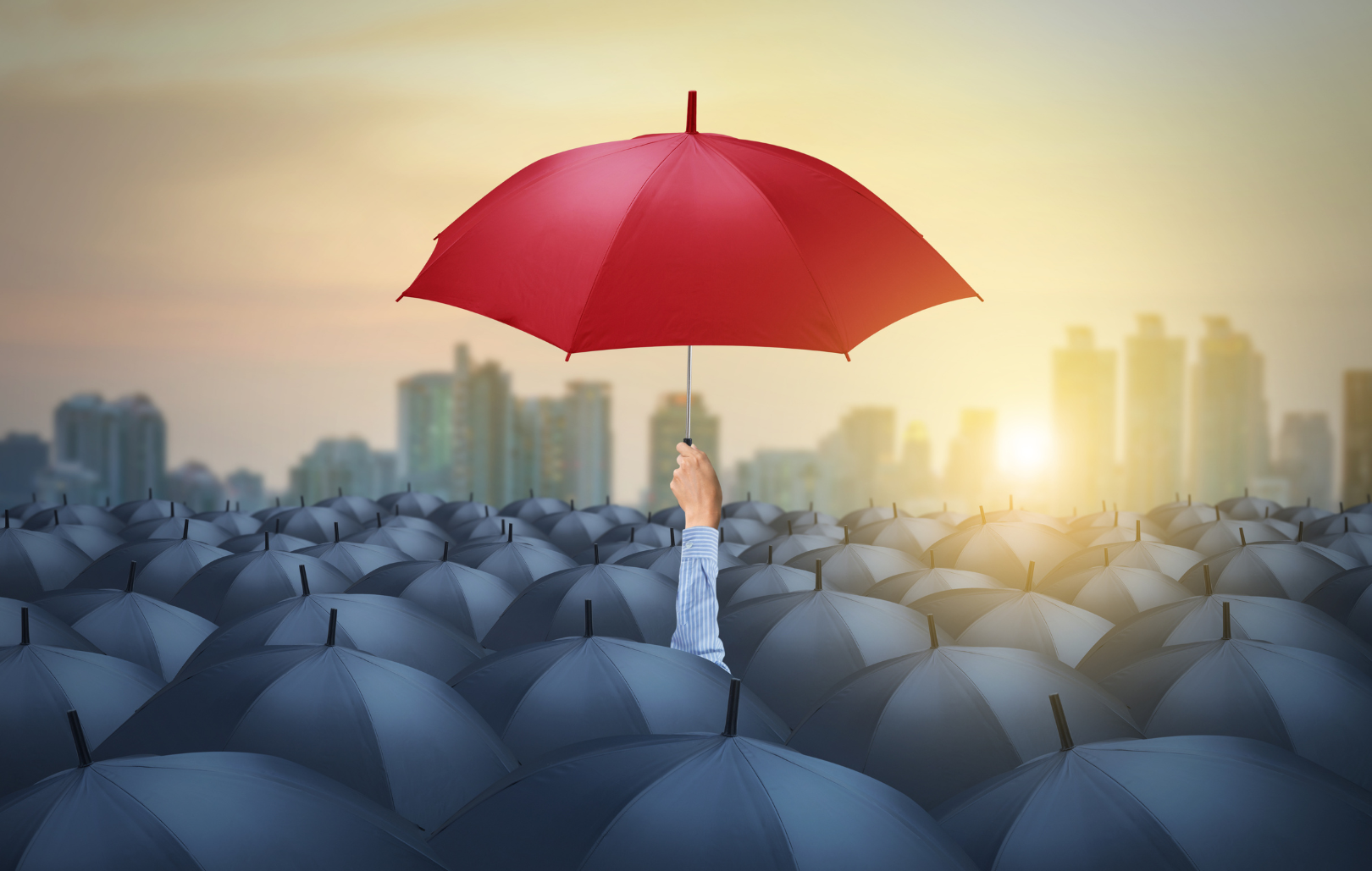 A black umbrella with a single red symbol representing corporate recruitment.